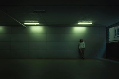 Person standing alone in dim hallway – symbolic of seeking emotional support and online coaching