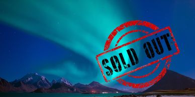 Northern lights over mountains with a sold out stamp.