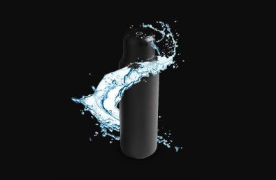 Black bottle wrapped in a splash of water.