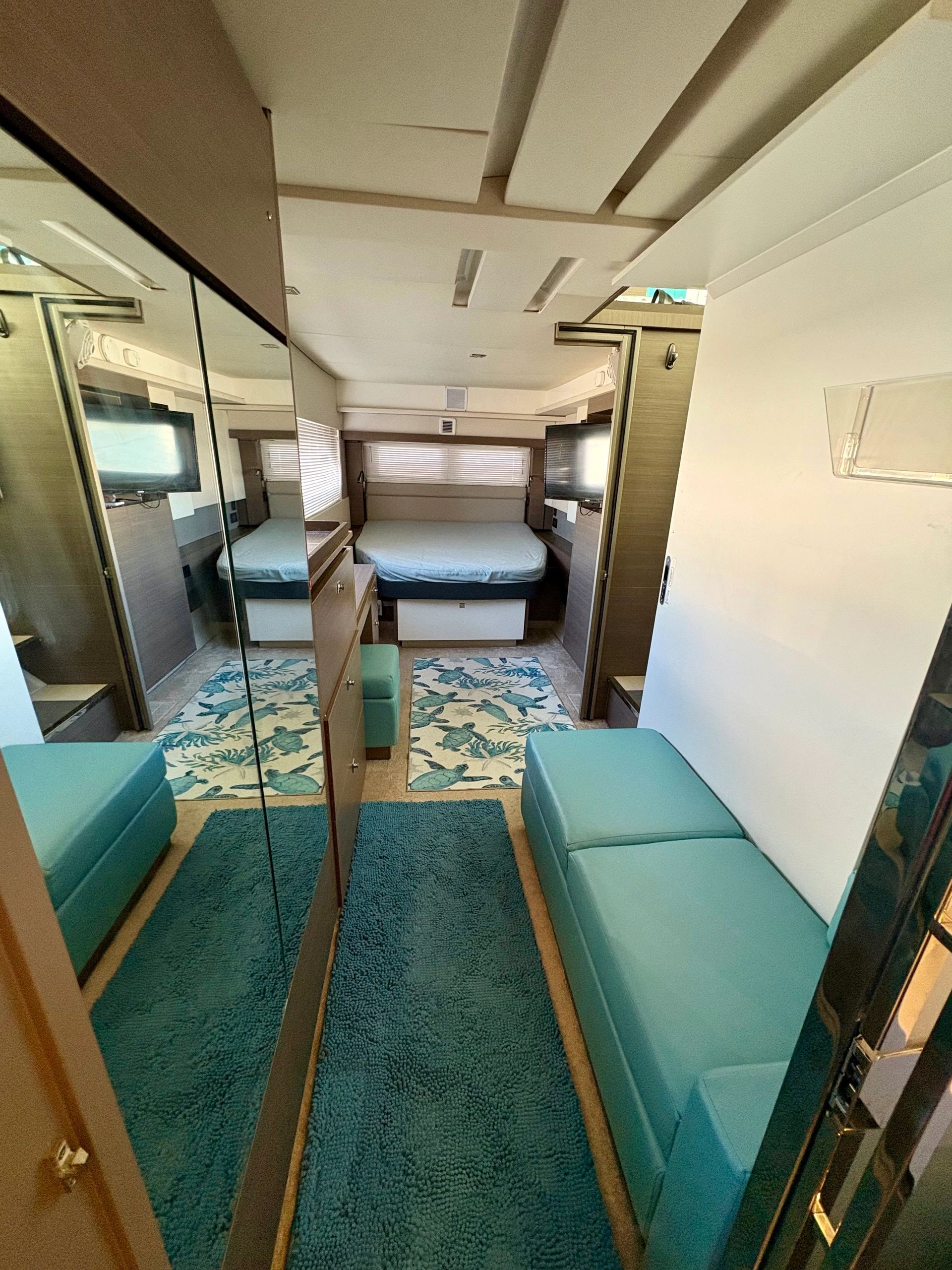 Cozy bedroom with teal accents and mirrored closet doors.