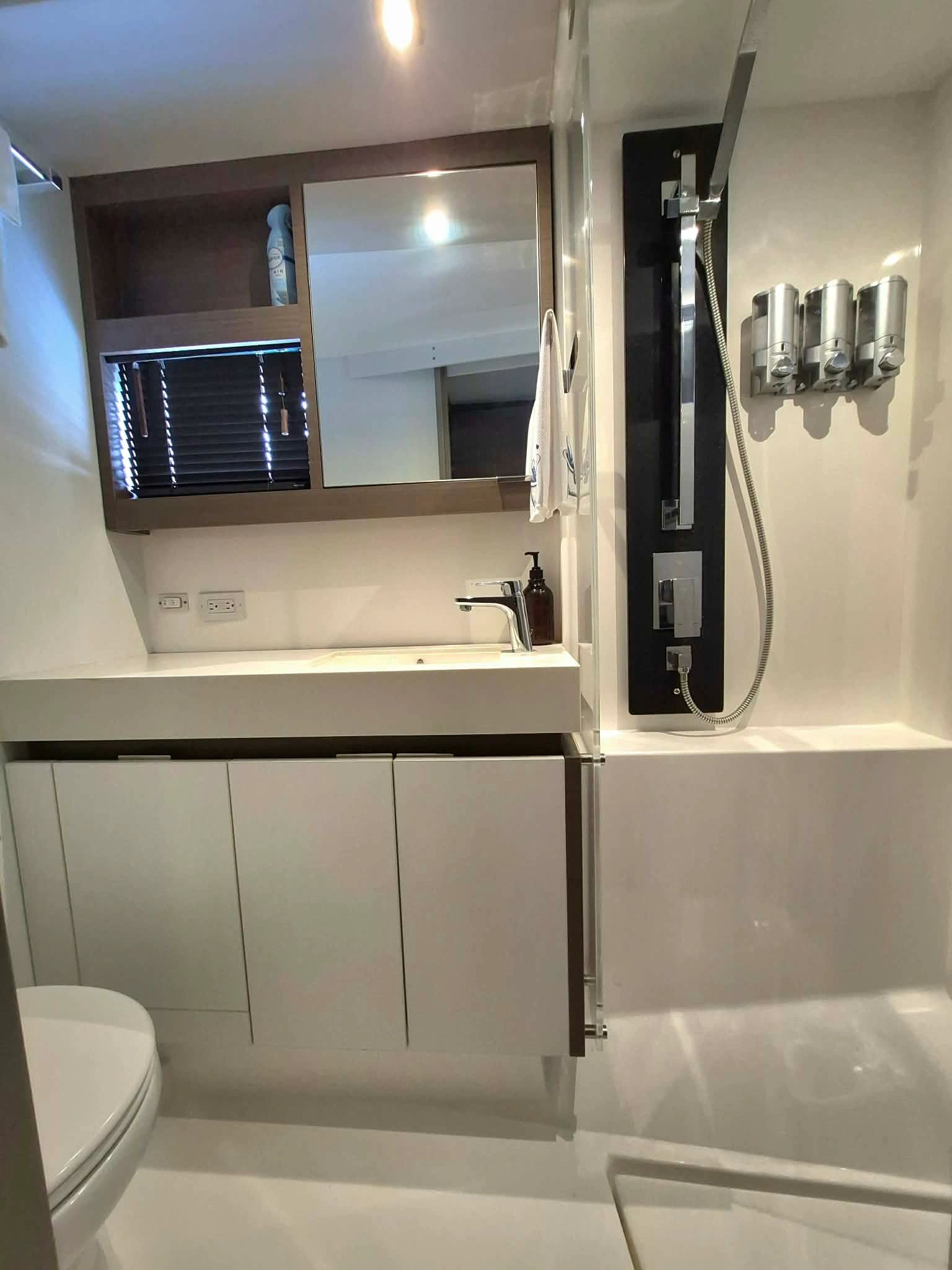 Modern bathroom with sleek fixtures and a glass shower door.