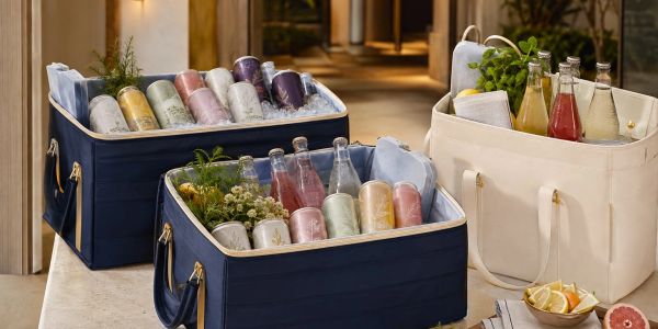 Three insulated bags filled with colorful drinks and herbs.