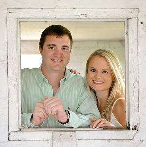 A couple poses for their engagement photos. We specialize in the perfect setup and lighting to meet all of your professional portrait requirements.