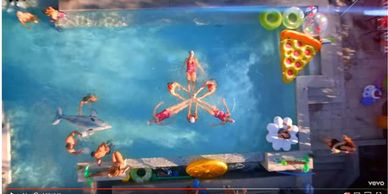 Aquatic performers with water ballet, water waitresses and pool party extras in music video