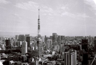 Black and white cityscape with a tall tower.