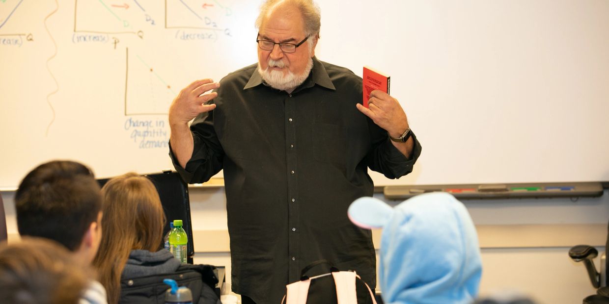 Lew engages a class of high-school students (including one with ears on her hood!).