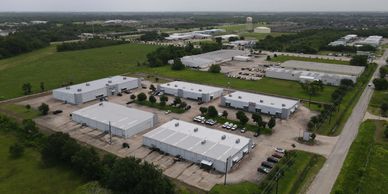 Aerial view of an industrial park with multiple warehouse buildings and parking areas.