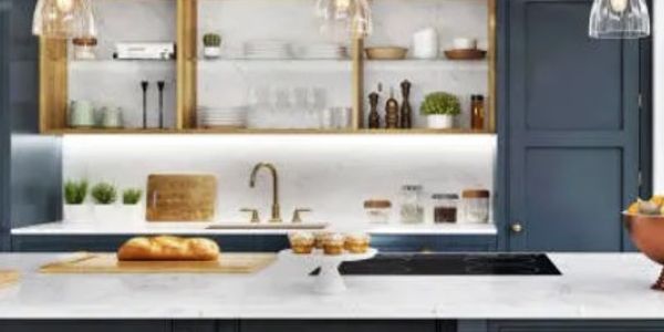 Modern kitchen with blue cabinets and marble countertop.