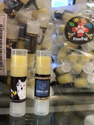Two tubes of PawPat lip balm with bee and dog designs.