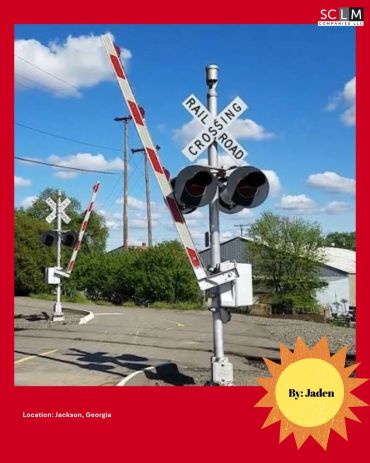 Railroad crossing gates raised on a clear day.