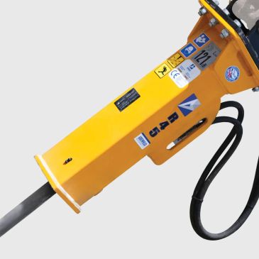 Yellow hydraulic breaker attachment with various stickers and a hose.