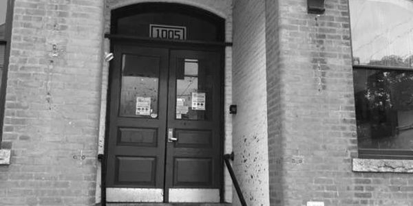 Black double doors with the number 1005 above them.