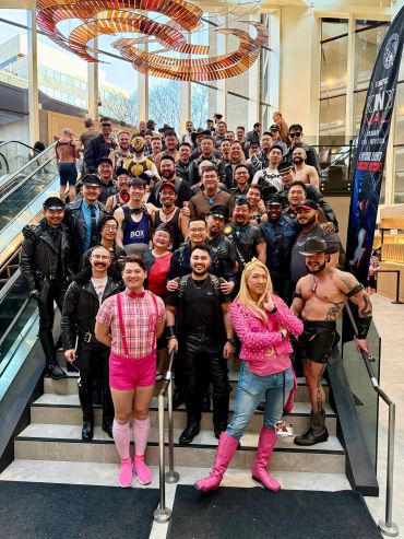 Group of people in diverse costumes on stairs.