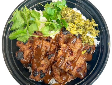 Grilled meat with sauce, rice, herbs, and pickled vegetables in a bowl.