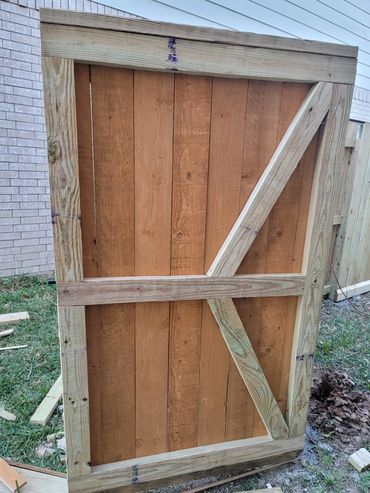 Wooden gate door with bracing frame.