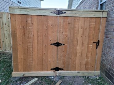 Wooden gate with metal hinges and latch.