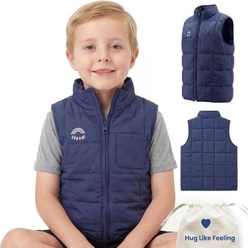 Smiling boy wearing a navy blue sleeveless vest.