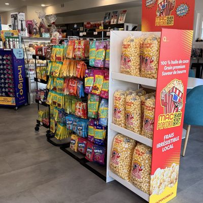 Popcorn display and snack aisle in a store.