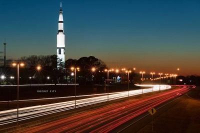 Rocket City skyline with a towering rocket at dusk.