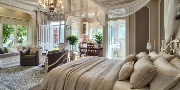 Cozy bedroom with elegant decor and attached sitting area.
