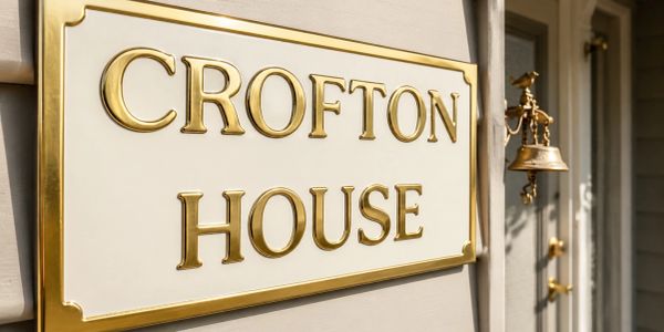 Elegant house sign with golden letters.