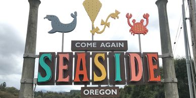 Colorful welcome sign for Seaside, Oregon with sea creatures on top.
