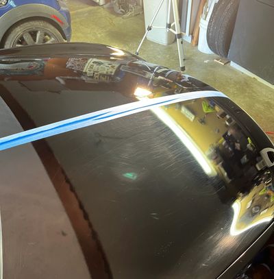 Side by side image of a black Infiniti g37 hood. Paint correction near Cincinnati.
