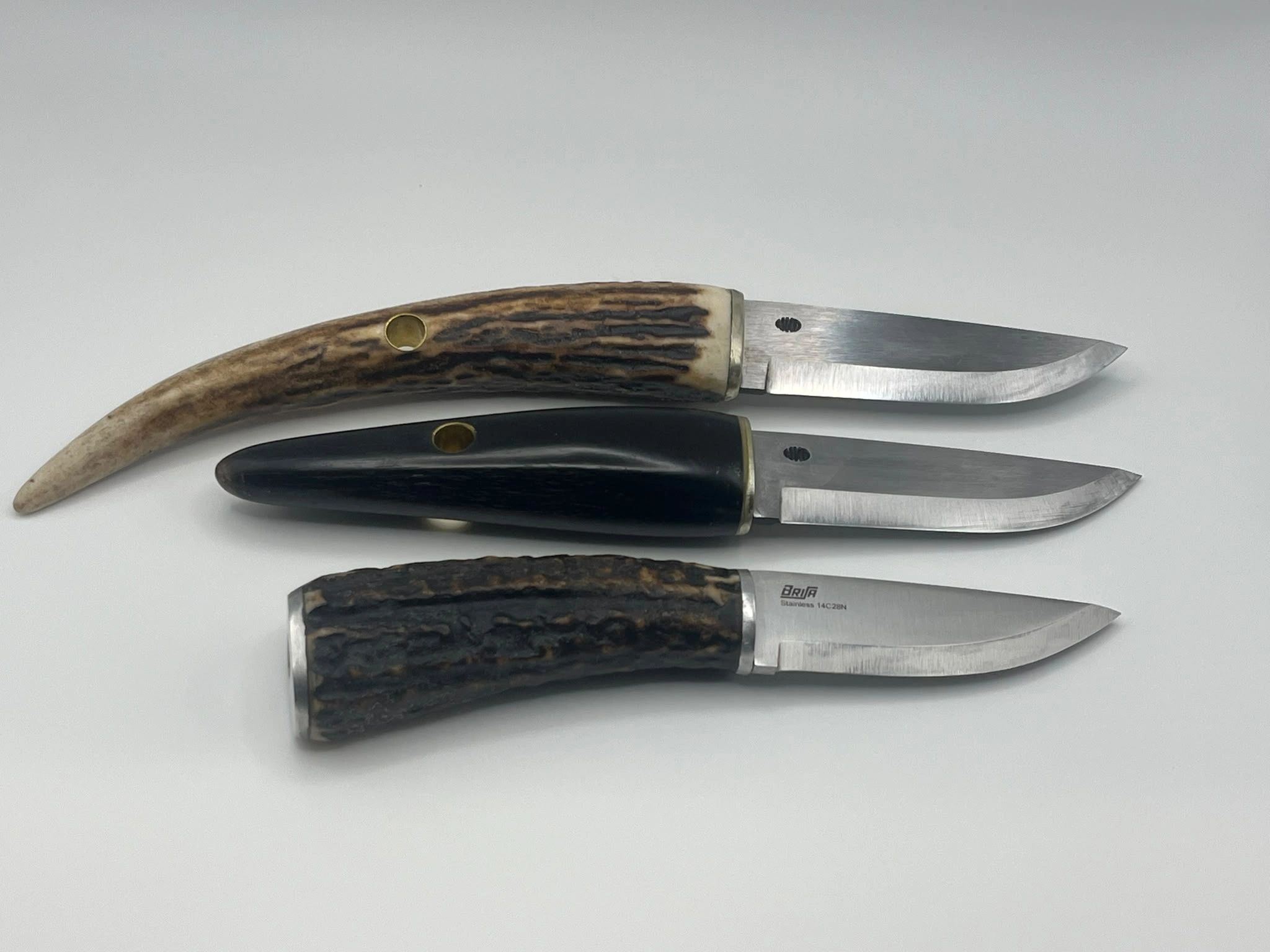 Three knives with unique handles and blades.