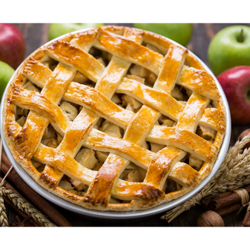 Golden lattice apple pie surrounded by apples and cinnamon sticks.