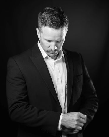 man adjusting his suit