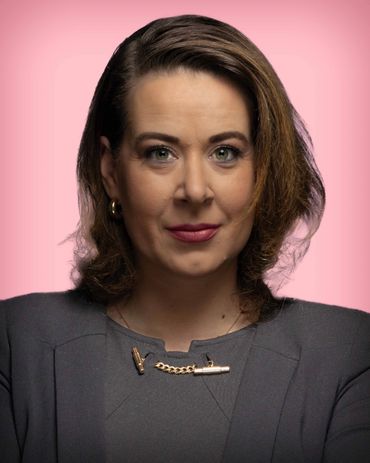 woman with green eves pink background