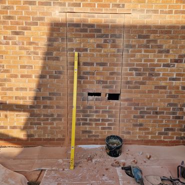 Brickwork cut out neatly to take new Upvc door to side of garage.