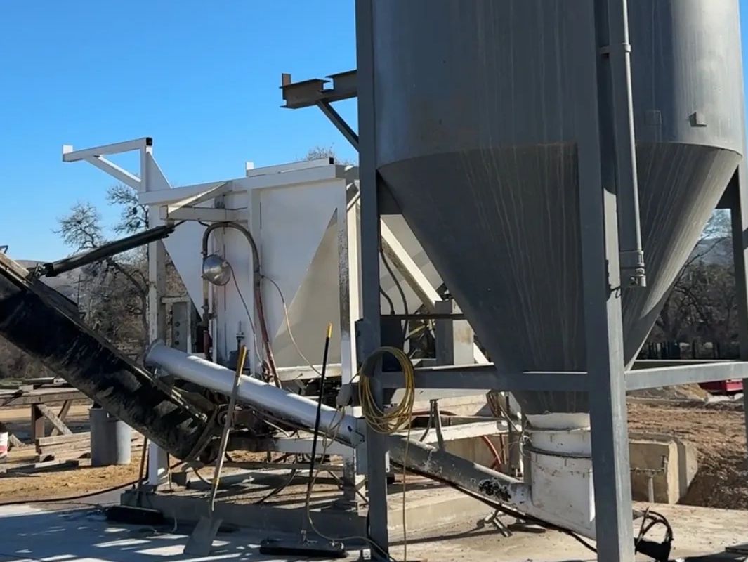 Industrial concrete mixing equipment outdoors.
