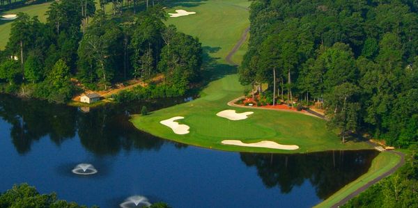 A scenic golf course with water hazards and lush greenery.