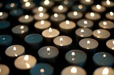 Many lit tealight candles creating a warm, glowing ambiance.