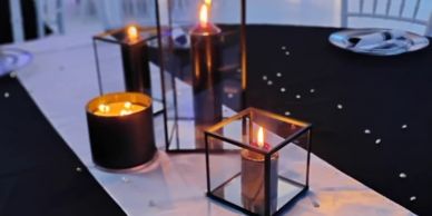 Candles glowing on a table with a black and white theme.