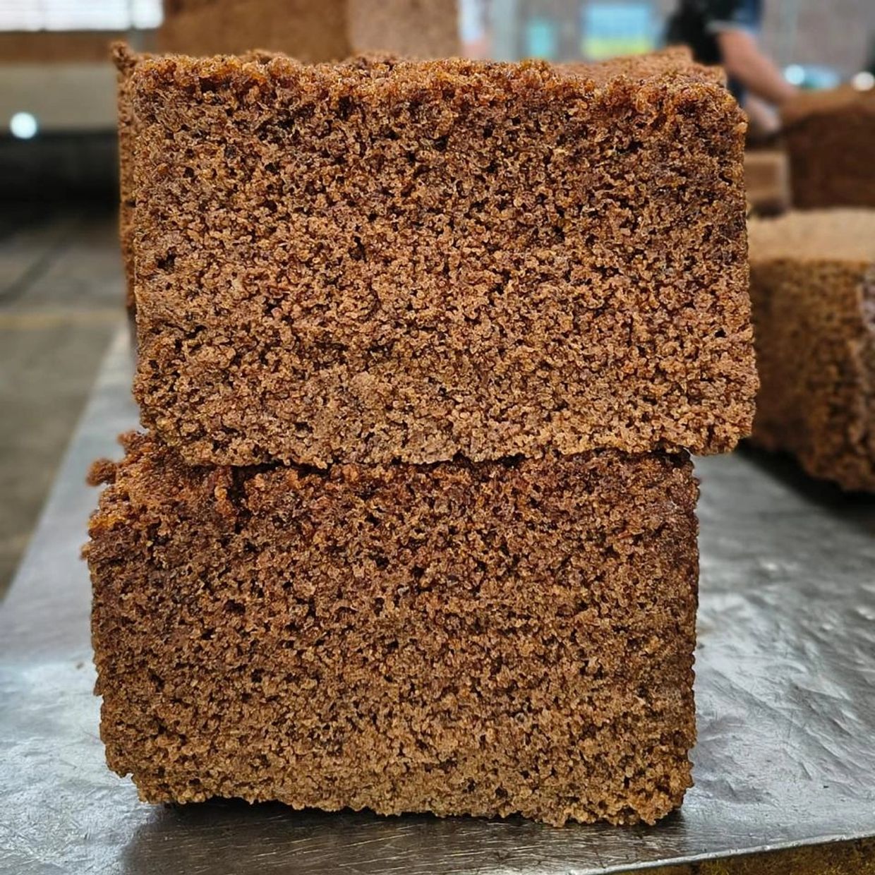 Two pieces of brown sponge cake stacked.