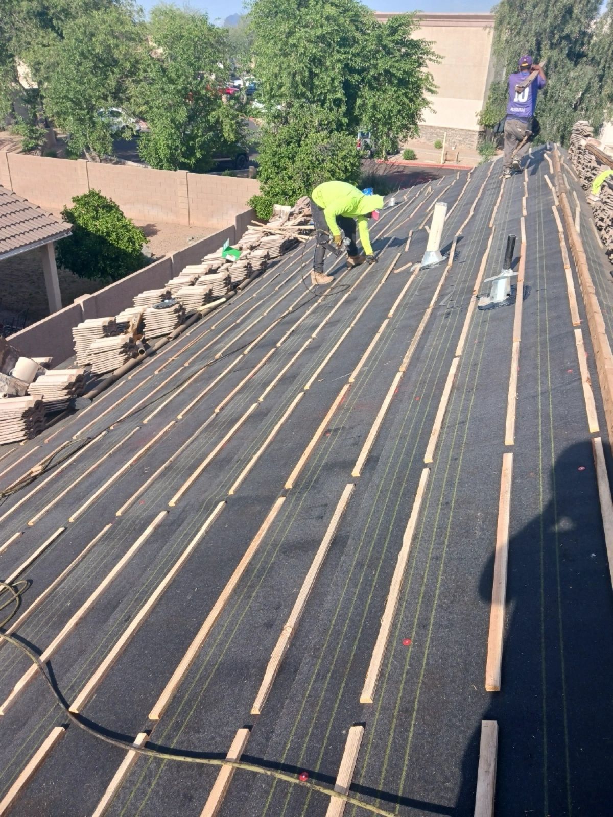 Tile roof underlayment replacement with battens installed before the existing roof tiles are reset