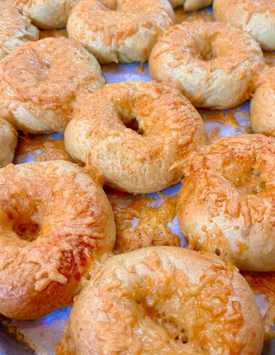Freshly baked cheese bagels with a golden crust.
