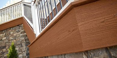Close up of Trex Composite Fascia board in saddle brown showcases materials used by EZ Deck of RI