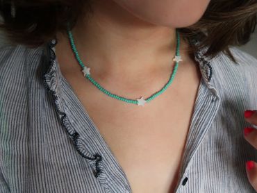 STAR necklace on a neck.