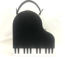 This piano purse is so fun and great for any musician!  Sparkly black body and lots of space inside.