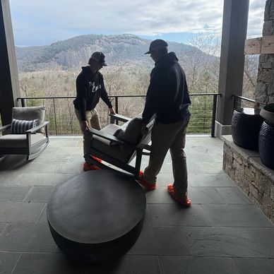 Professional cleaners moving upholstery after cleaning with a beautiful view of a Sapphire NC