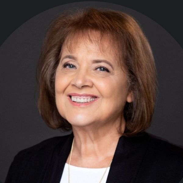 Smiling elderly woman with brown hair.
