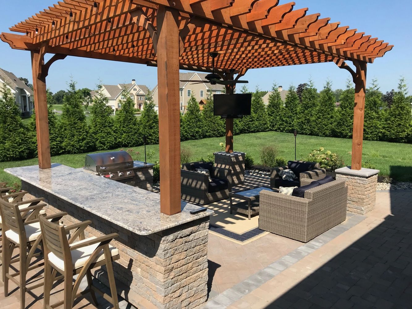 Paver patio with outdoor kitchen and cedar pergola