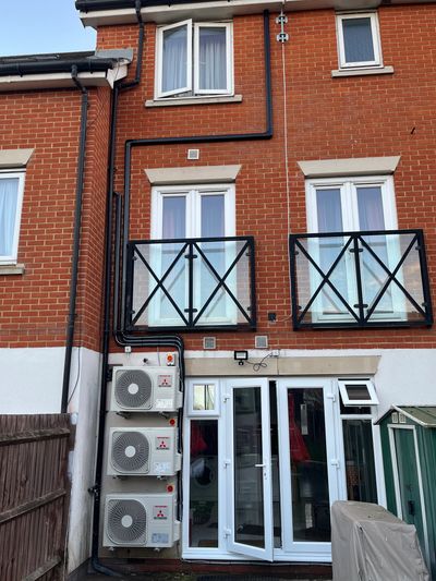 Three air conditioning condensers installed on a wall