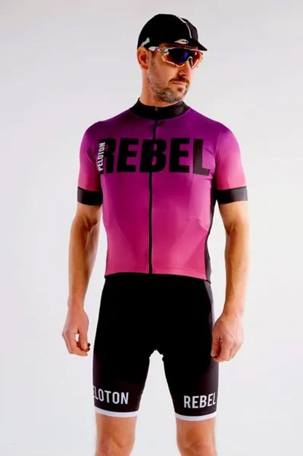 A model is wearing a short sleeved pink and black Peloton Rebel cycling jersey 