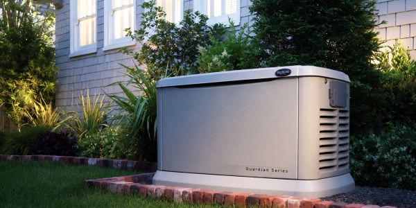A Guardian Series home standby generator installed outside a house.