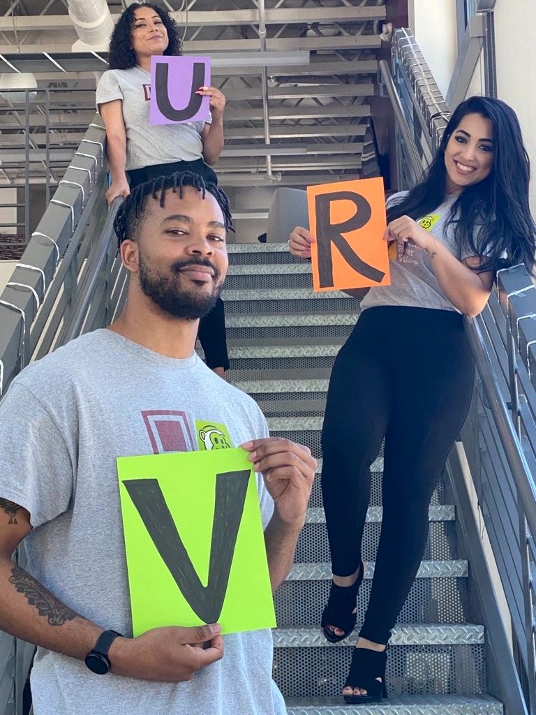 Staff holding the letters URV