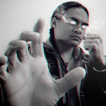 Person with glowing eyes and blurred hand reaching forward.